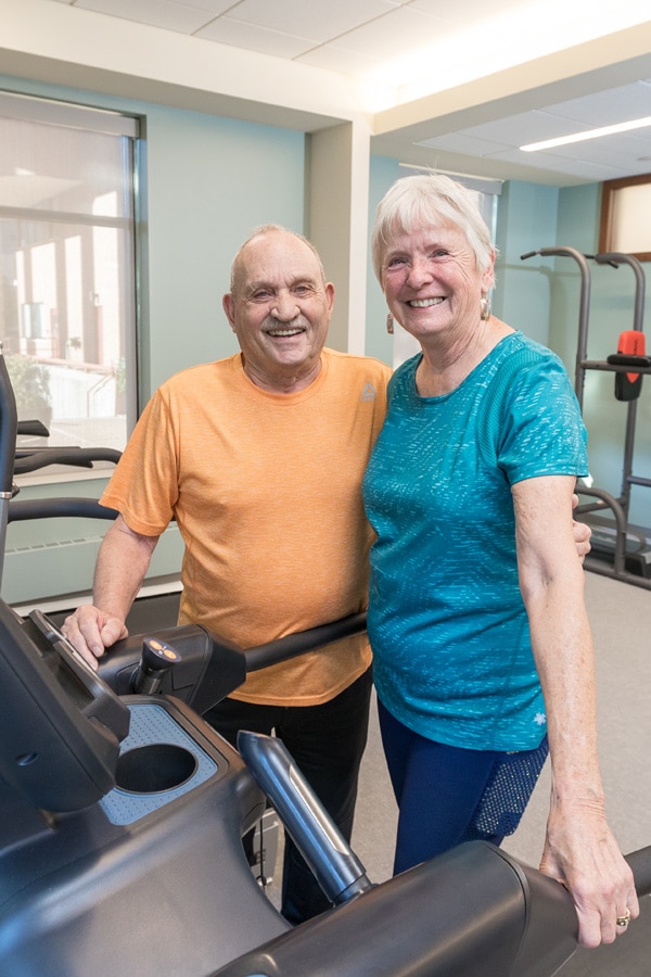 Man And Woman Smiling After Elliptical Workout Man And Woman Smiling After Elliptical Workout