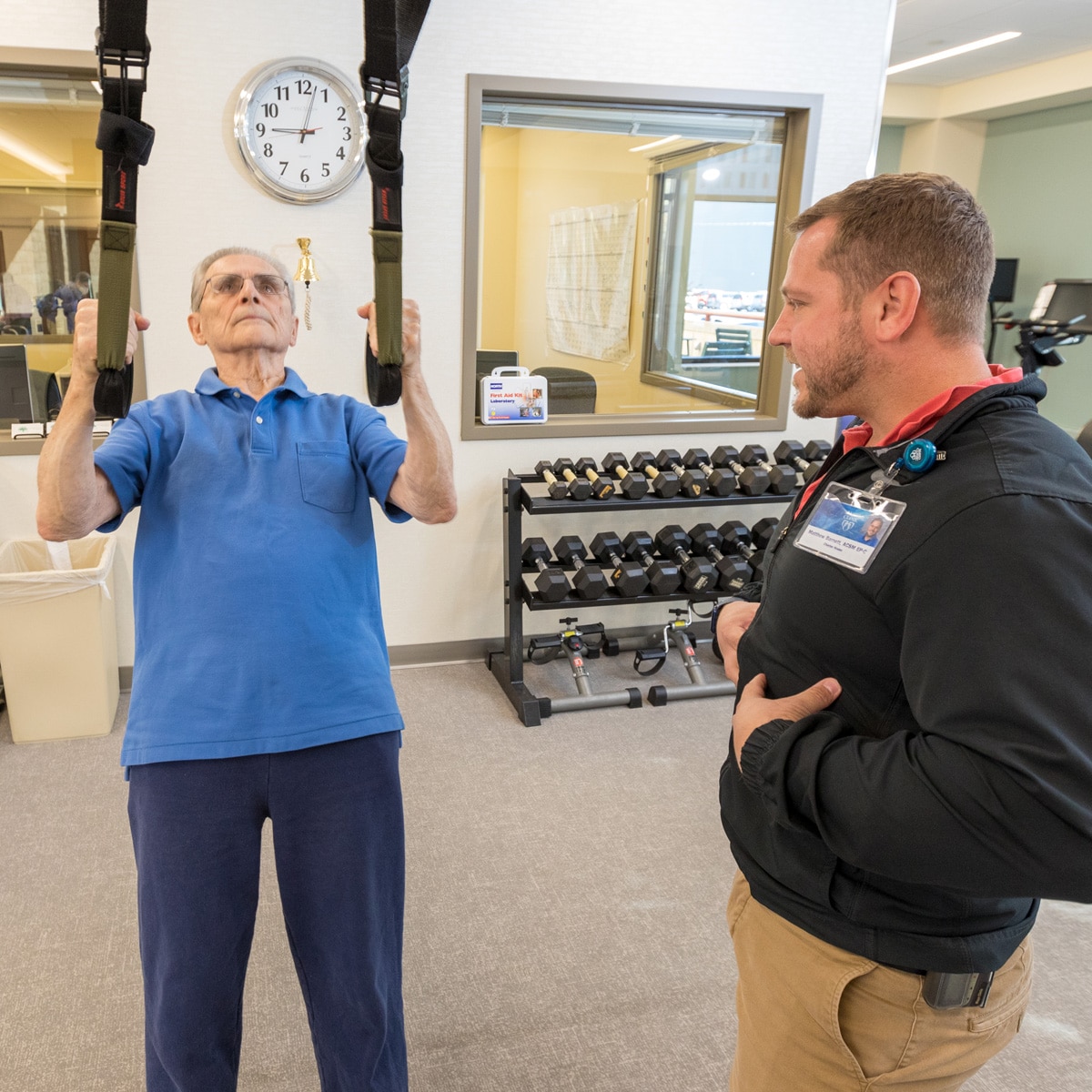 Fitness Instructor Assisting Resident On Fitness Straps Fitness Instructor Assisting Resident On Fitness Straps